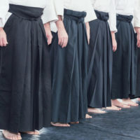 People in kimono and hakama standing in a line on tatami People in kimono and hakama standing in a line on tatami